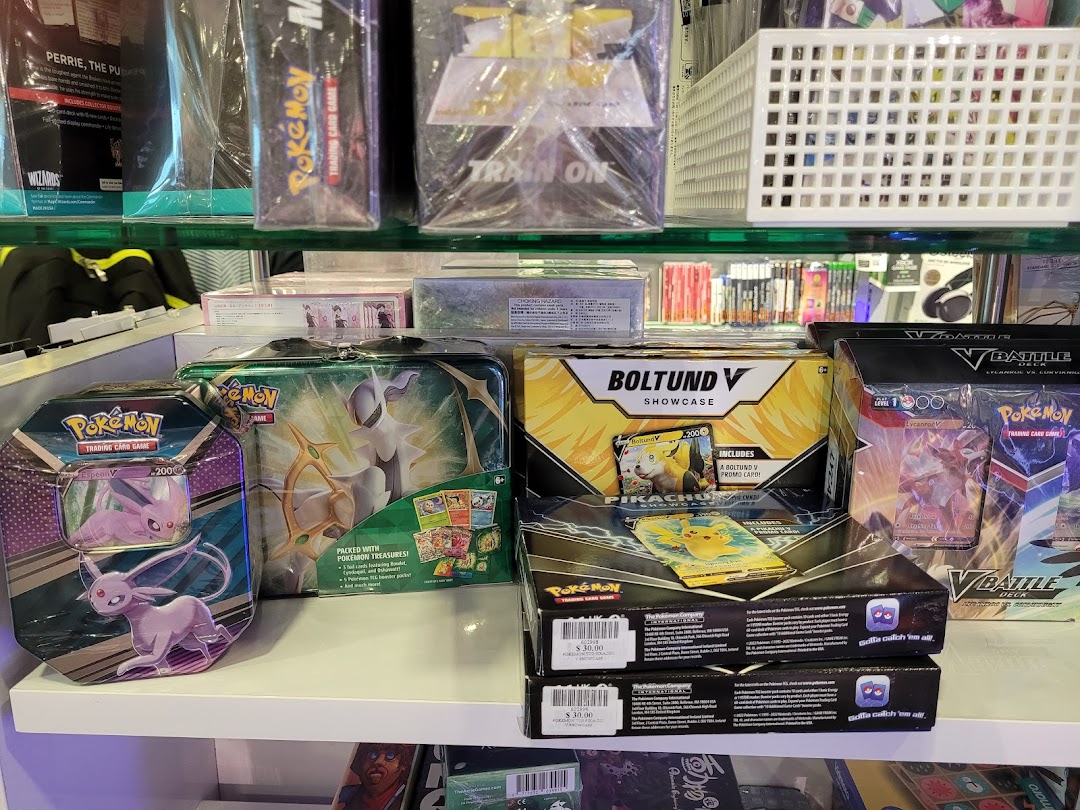 A shelf displaying various Pokémon Trading Card Game products, including tins, boxes, and booster packs.