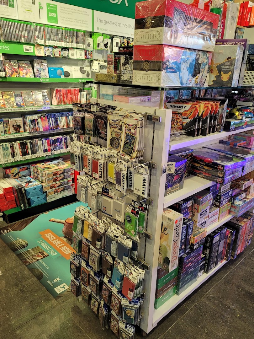 An interior view of TOG - Toy Or Game Plaza Singapura, showcasing shelves packed with video games, board games, and trading card supplies.