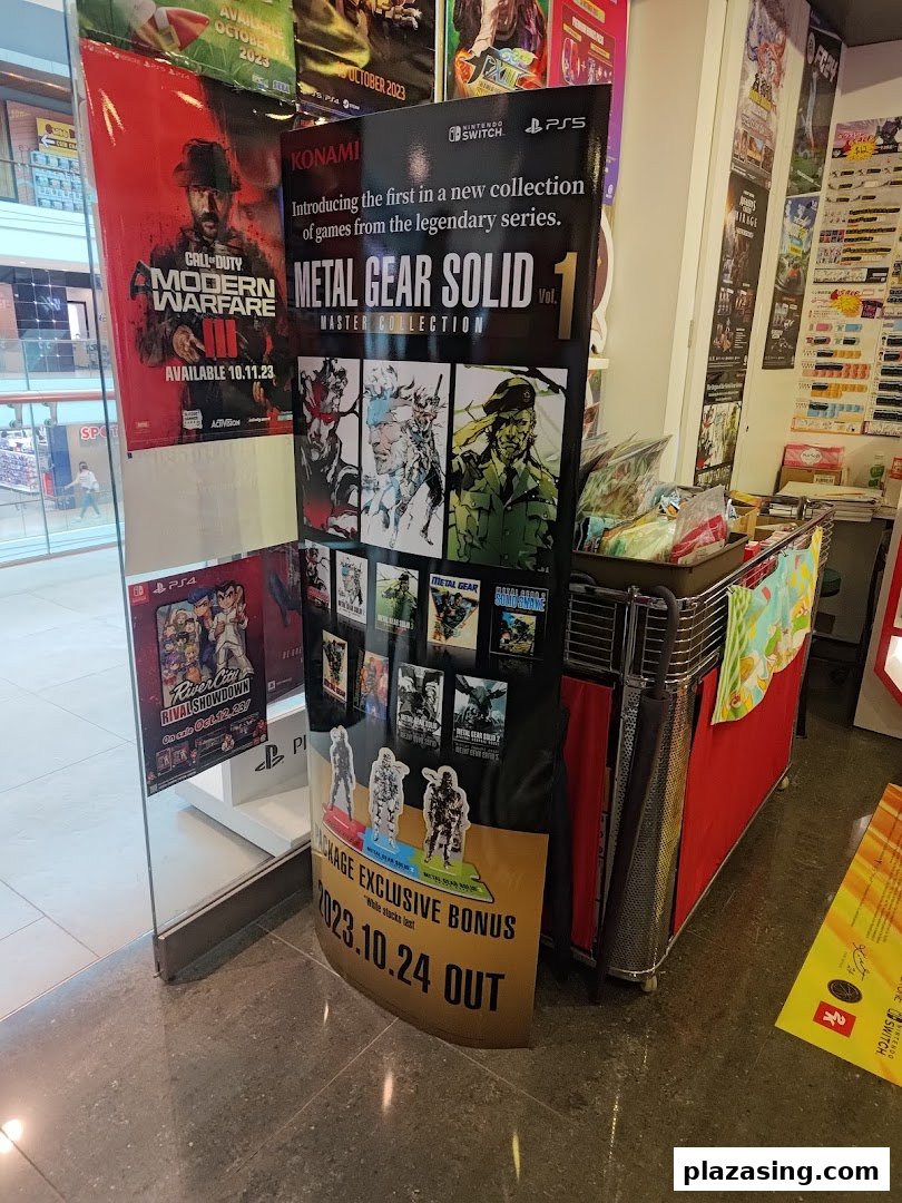 Promotional displays for new video game releases like Metal Gear Solid and Call of Duty inside a game store.