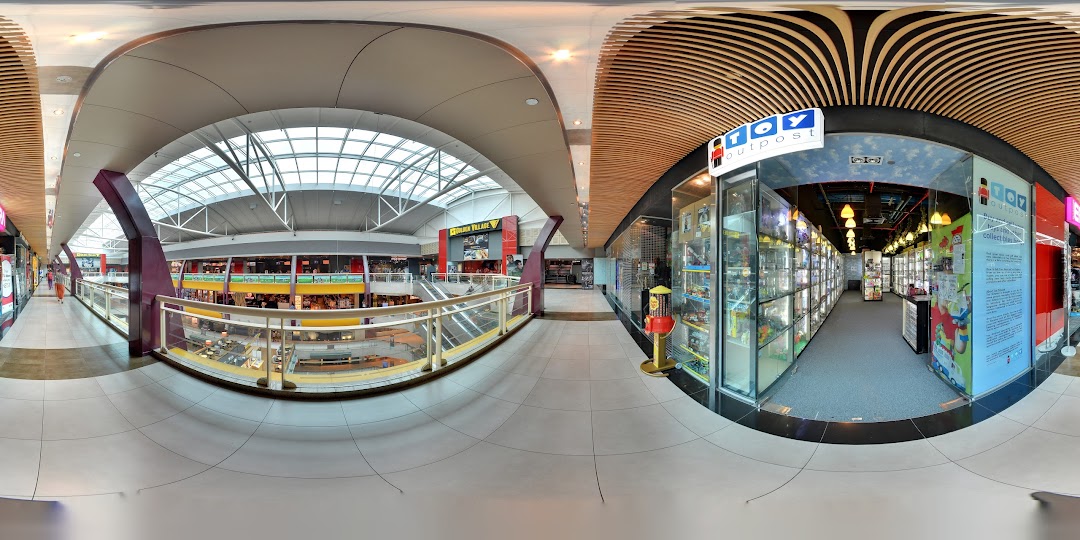 The entrance of Toy Outpost in Plaza Singapura, showcasing display cases filled with collectibles and toys.
