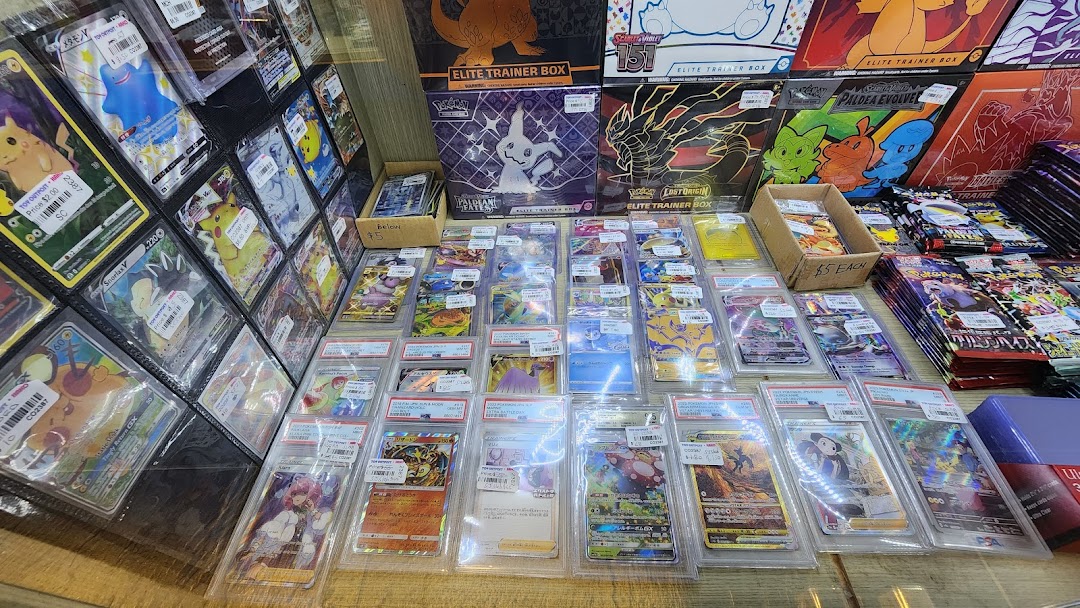 A vibrant display of Pokémon trading cards, including rare singles, graded cards, and sealed booster boxes.