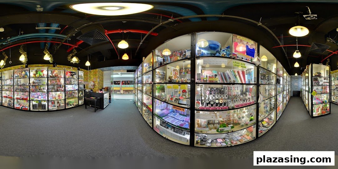A panoramic view of Toy Outpost's interior, showcasing numerous glass display cases filled with diverse toys, collectibles, and novelty items.