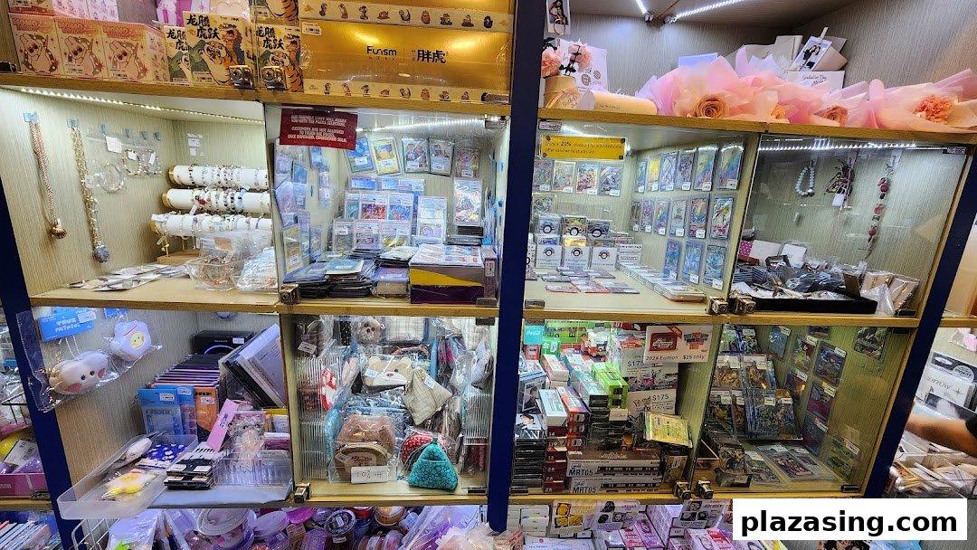 Brightly lit display cases showcasing a diverse collection of trading cards, jewelry, and various small gifts.