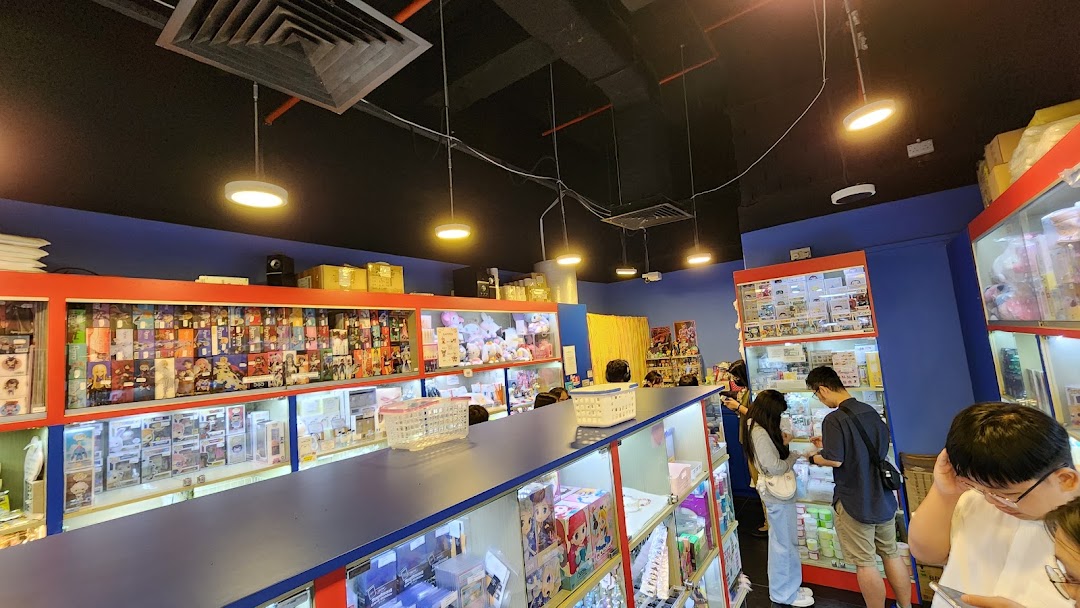 Interior view of Toy Outpost, a vibrant shop filled with collectible toys, figures, and merchandise displayed in glass cases.