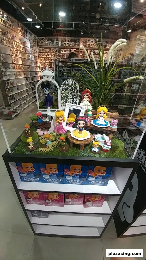 A vibrant display case featuring popular character figurines like Disney princesses and other collectibles, with shelves of boxed items.