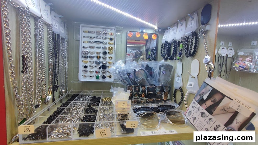 A retail display shelf showcasing various accessories like necklaces, rings, sunglasses, and temporary tattoos.