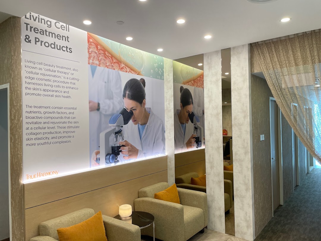 An inviting waiting area at True Harmony, featuring a detailed display about Living Cell Treatment & Products.
