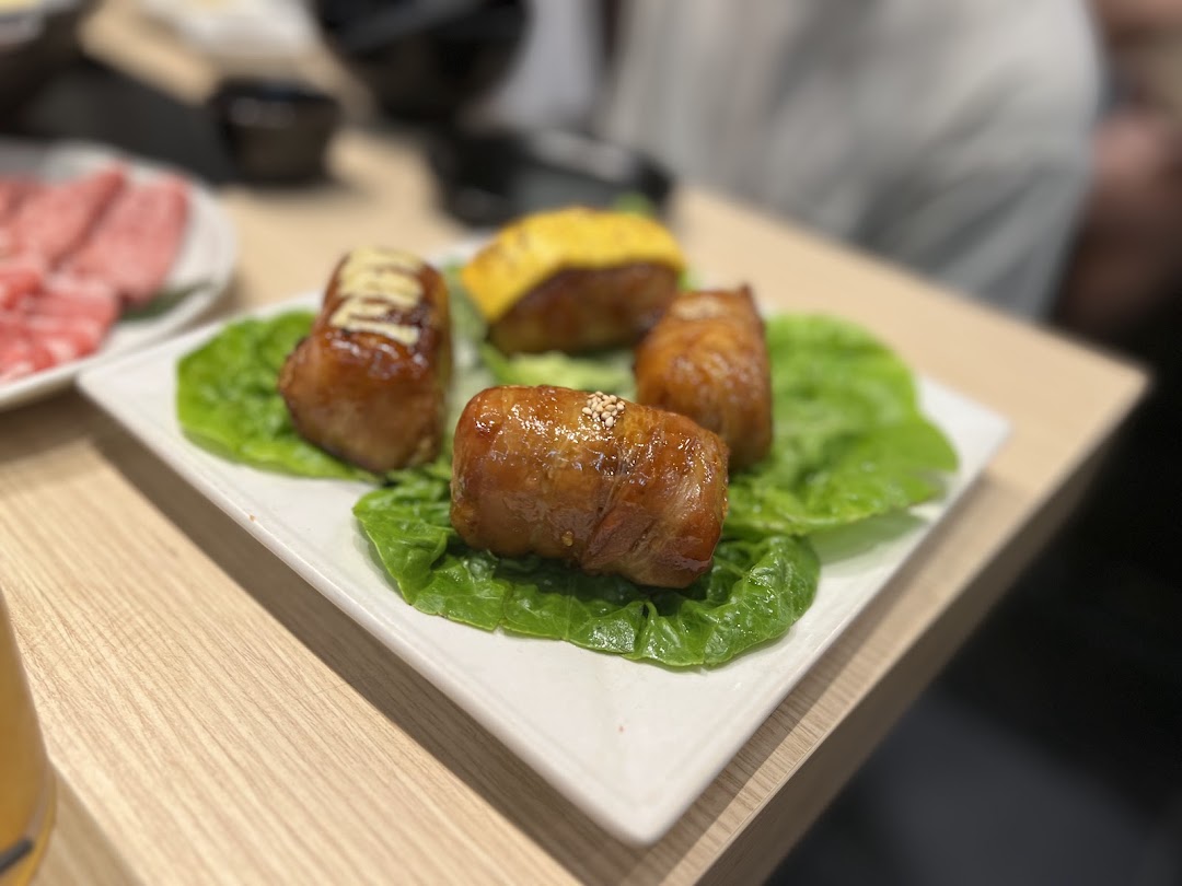 A plate of delicious-looking glazed chicken rolls served on fresh lettuce leaves.