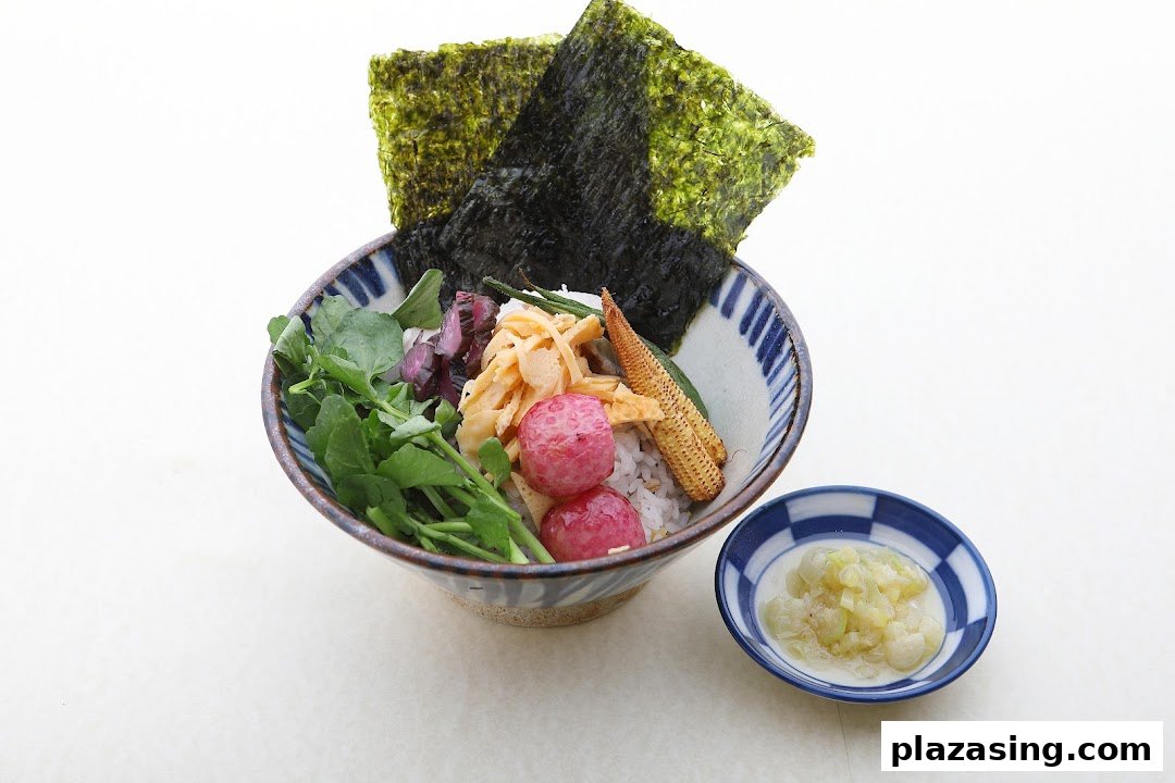 A vibrant Japanese rice bowl featuring fresh vegetables, radishes, baby corn, and nori.