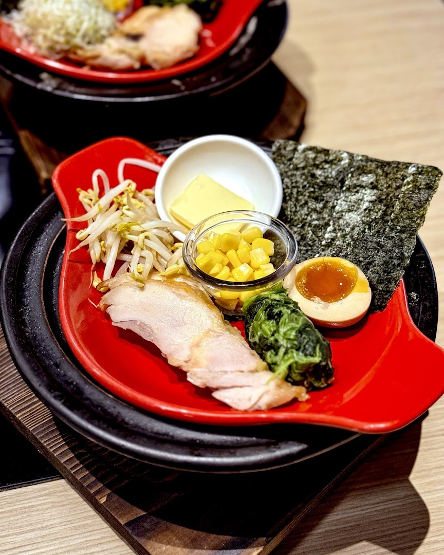 A vibrant Japanese dish featuring chicken, egg, corn, and fresh vegetables, ready for a hotpot experience.