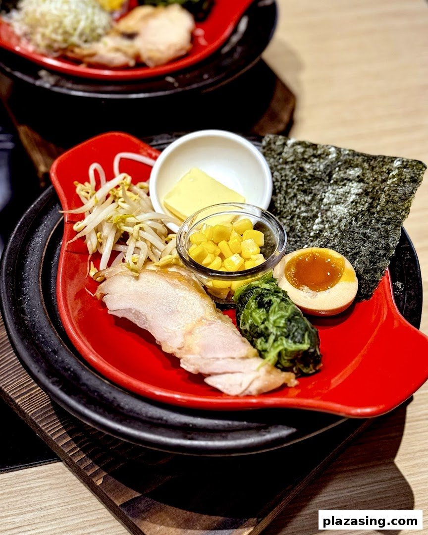 A vibrant Japanese dish featuring chicken, egg, corn, and fresh vegetables, ready for a hotpot experience.