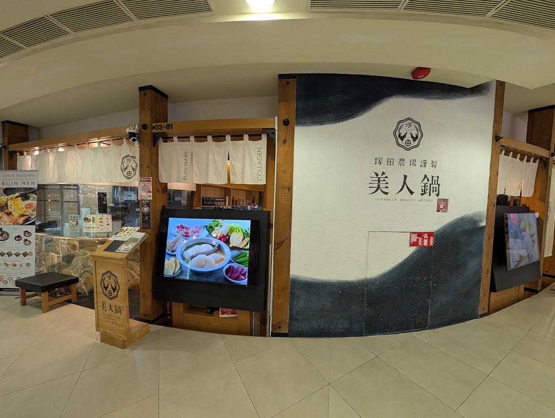 The inviting entrance of Tsukada Nojo, a Japanese hotpot restaurant, featuring traditional decor and digital displays.