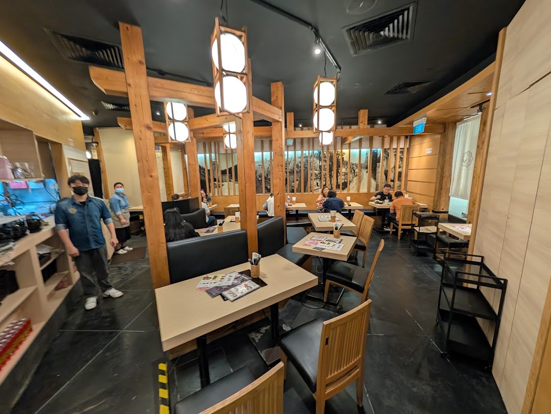 An interior view of Tsukada Nojo restaurant with customers dining and staff present.
