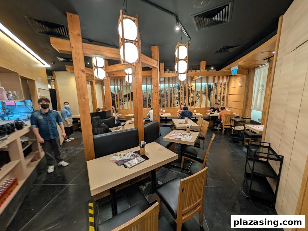 An interior view of Tsukada Nojo restaurant with customers dining and staff present.