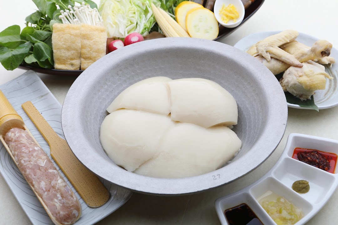 A vibrant spread of fresh ingredients for Japanese hotpot, featuring collagen-rich chicken stock and various accompaniments.