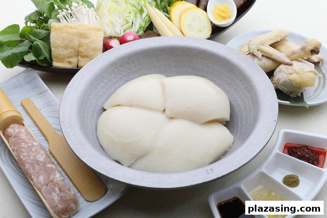 A vibrant spread of fresh ingredients for Japanese hotpot, featuring collagen-rich chicken stock and various accompaniments.