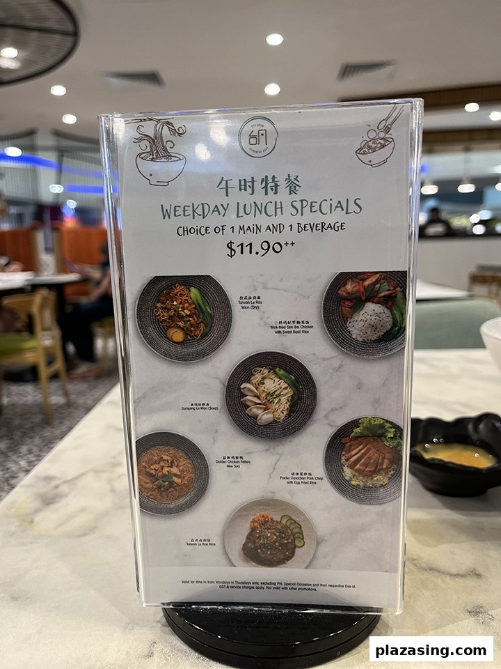 A menu stand displaying Typhoon Cafe's Weekday Lunch Specials with food photos and pricing.