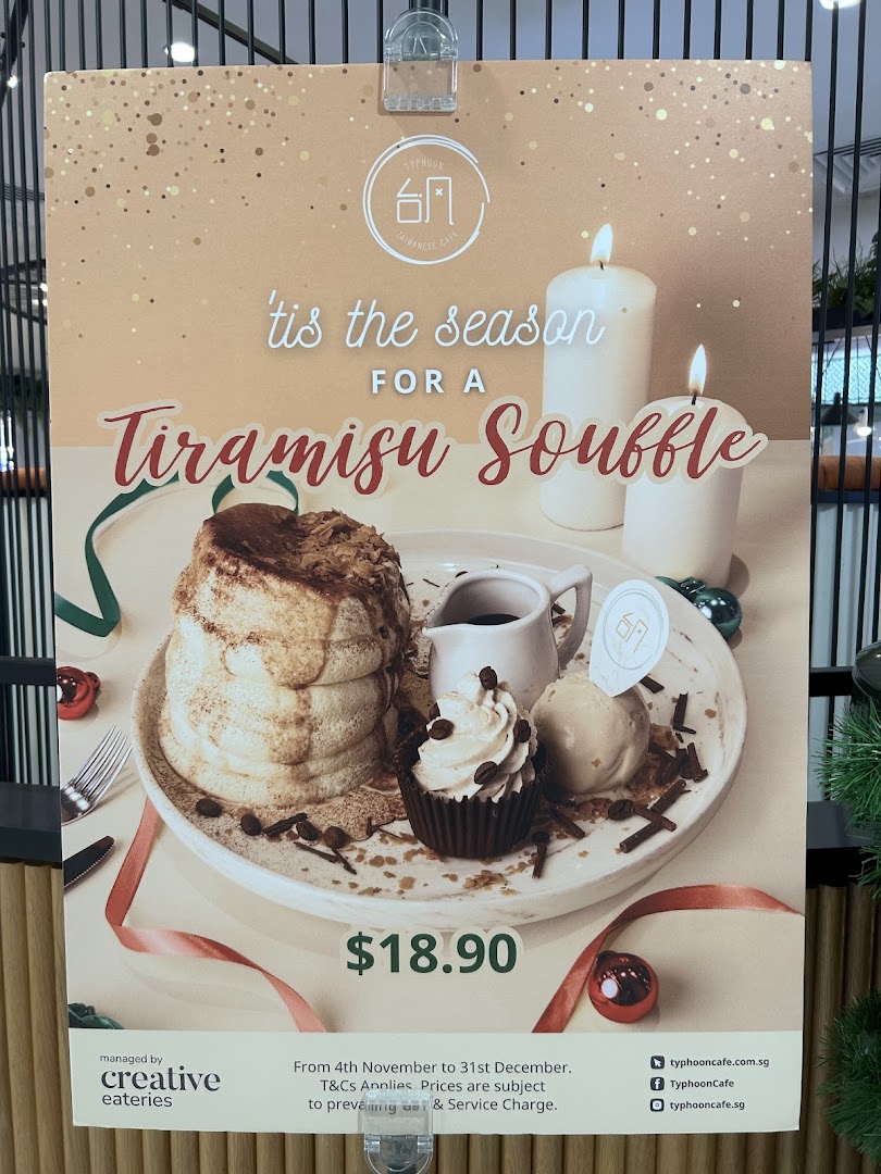 A promotional poster for Typhoon Cafe's Tiramisu Souffle, featuring the dessert, price, and festive decor.