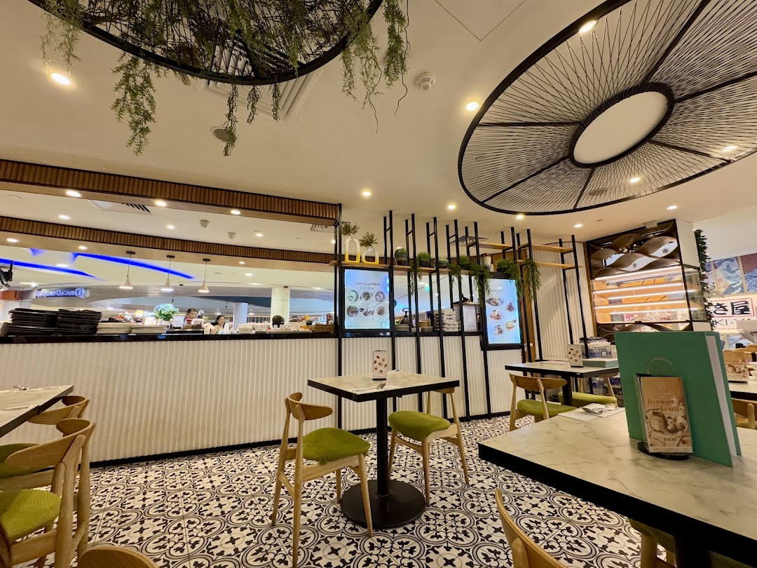 Interior view of Typhoon Cafe, showcasing its stylish decor, patterned floor, and comfortable seating area.