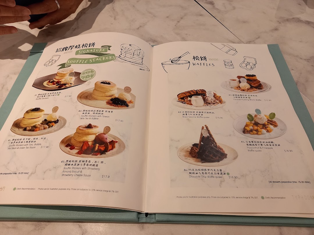 A detailed menu showcasing Soufflé Stackers and Waffles with various toppings and flavors.