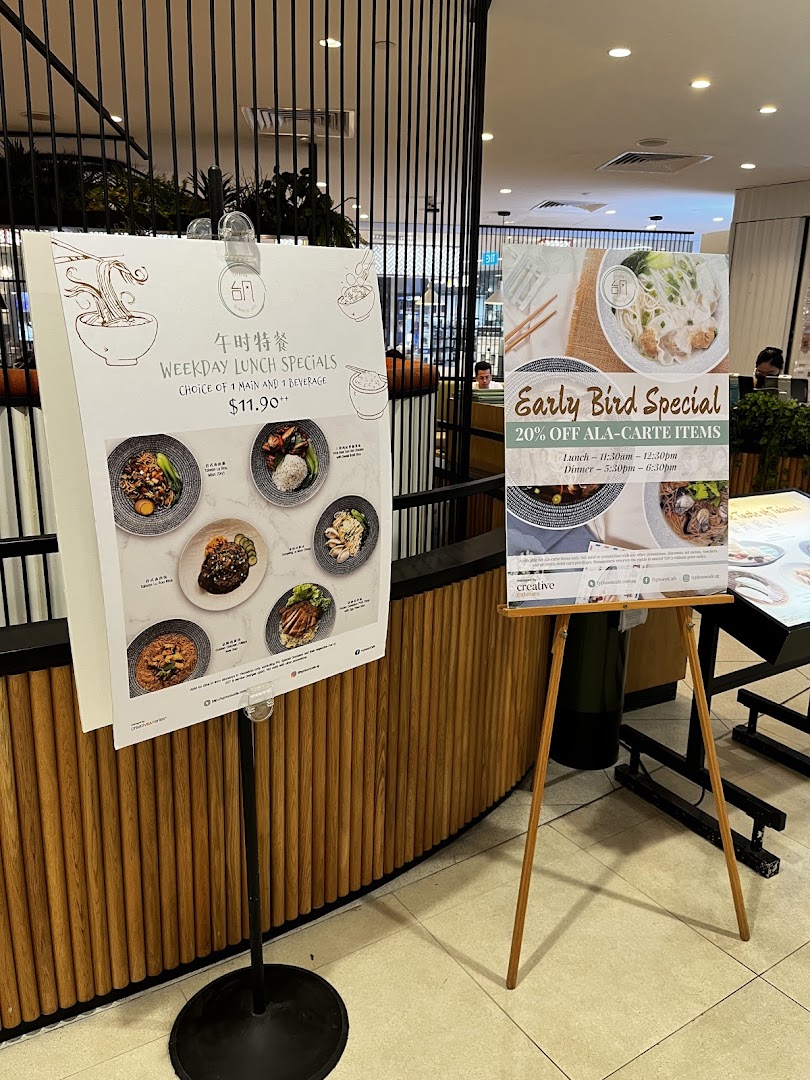 Two promotional stands outside Typhoon Cafe, showcasing weekday lunch specials and an early bird discount.