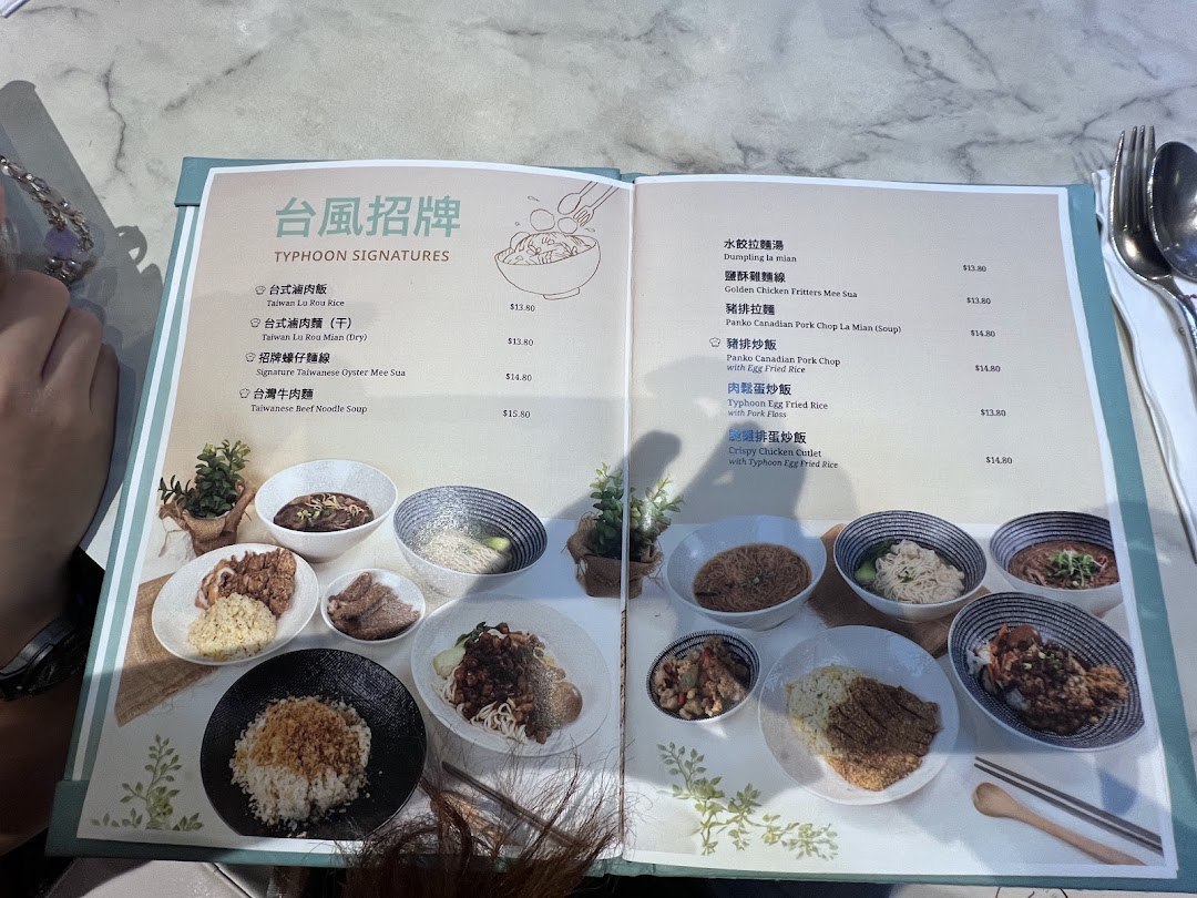 A detailed menu from Typhoon Cafe Plaza Singapura showcasing Taiwanese signature dishes and main courses.