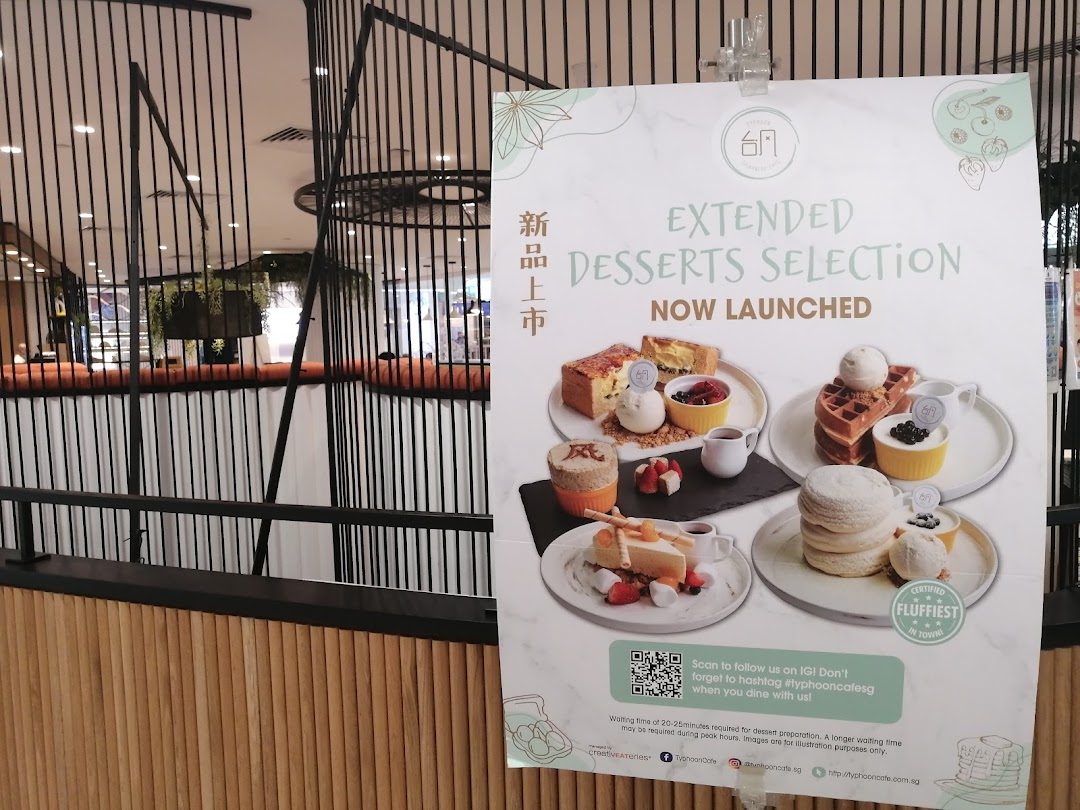 A promotional poster for Typhoon Cafe showcasing their new extended dessert selection with various sweet treats.