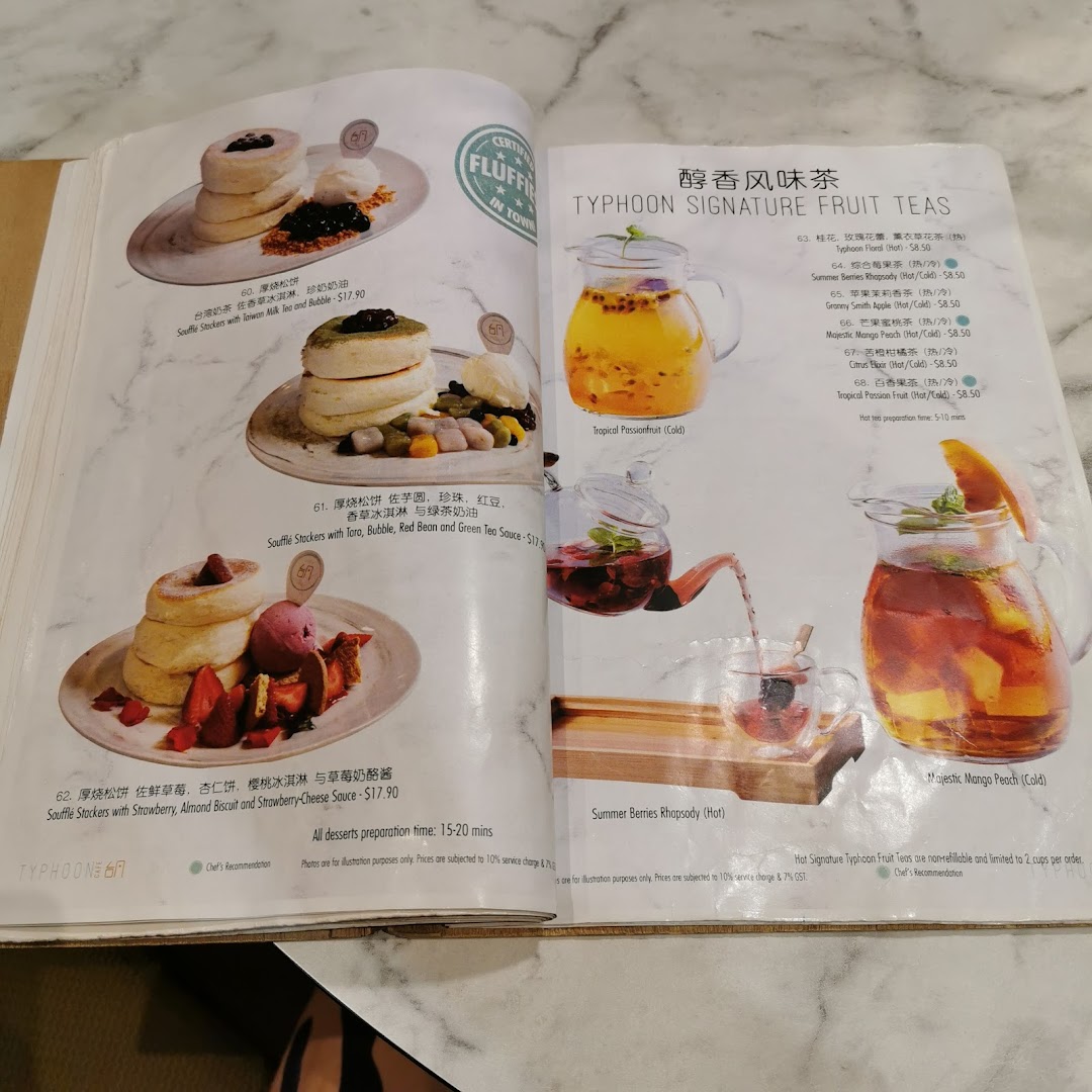 A detailed menu showcasing fluffy soufflé stackers and refreshing signature fruit teas.