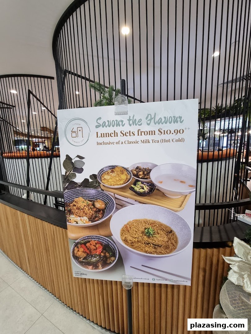 A promotional poster for Typhoon Cafe's lunch sets, featuring various Taiwanese dishes and a milk tea offer.