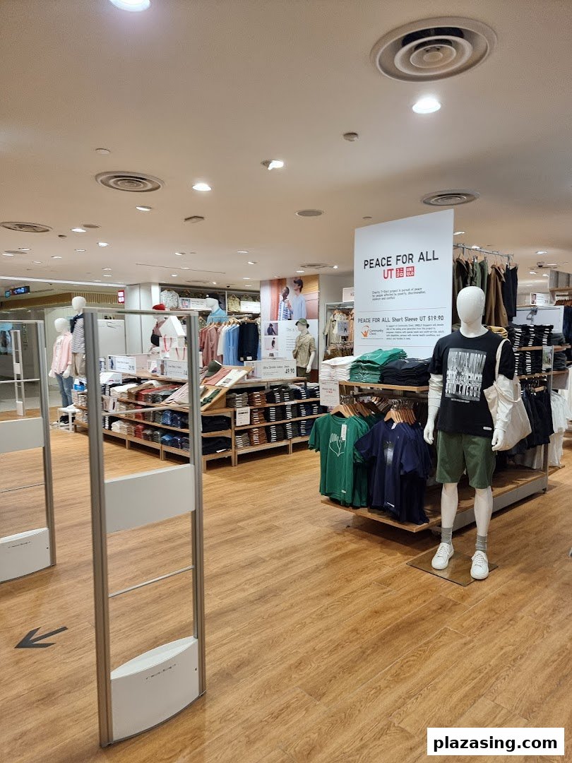 Interior view of UNIQLO, showcasing clothing displays, mannequins, and the store's spacious layout.