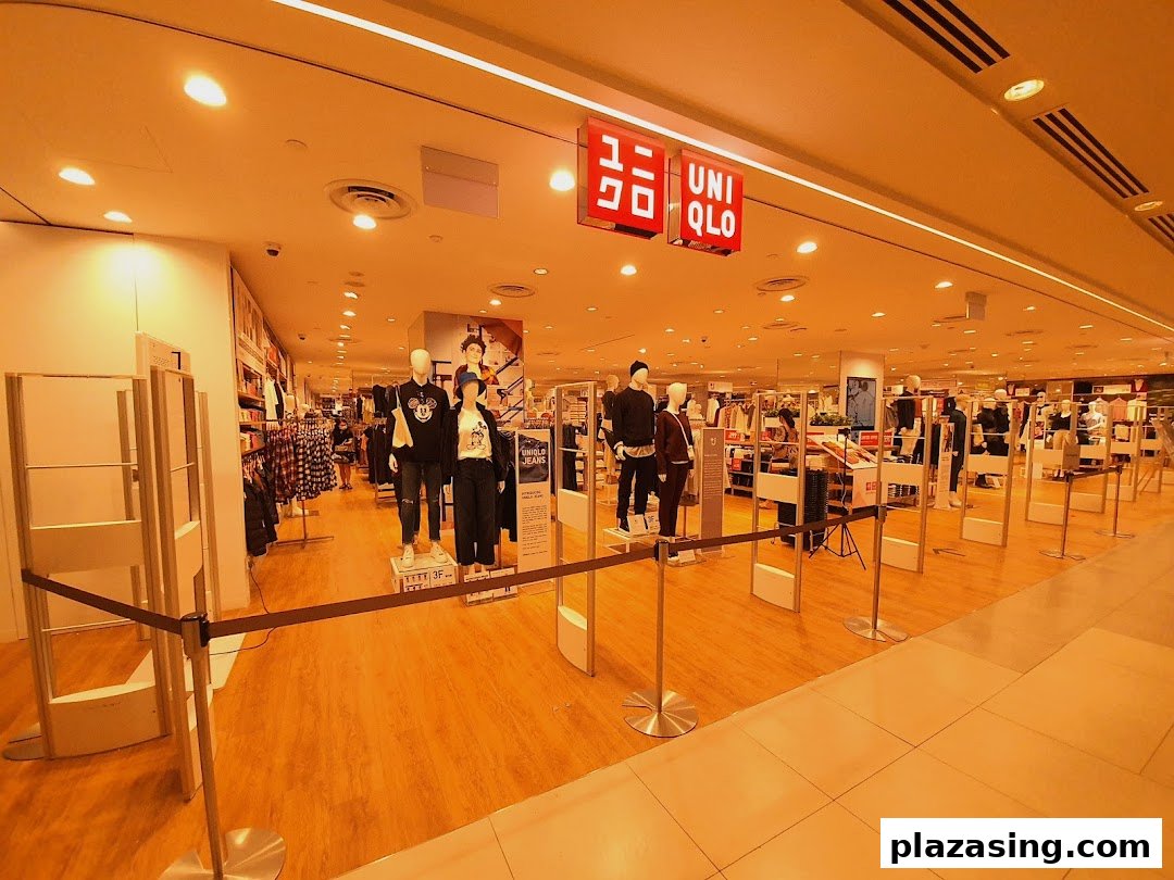 The entrance of UNIQLO Plaza Singapura, showcasing mannequins and a wide range of casual apparel.
