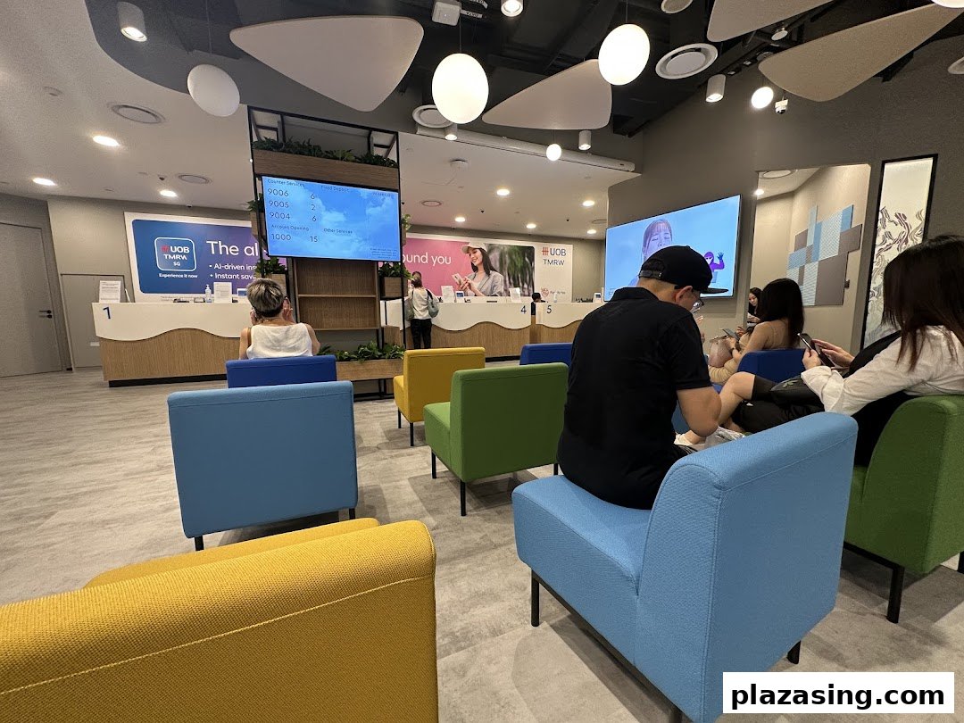 Customers wait in a modern UOB bank branch with colorful seating and digital displays.