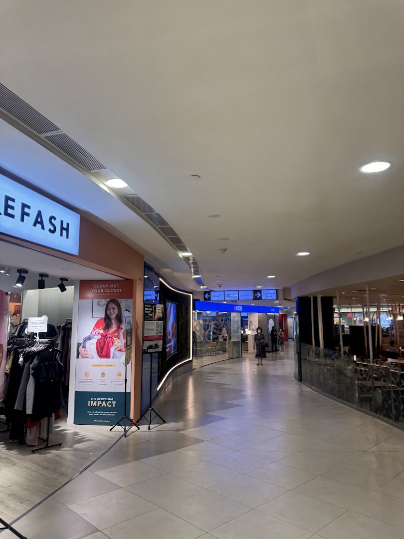 A mall interior showing the UOB branch entrance, other shops, and a wide walkway.