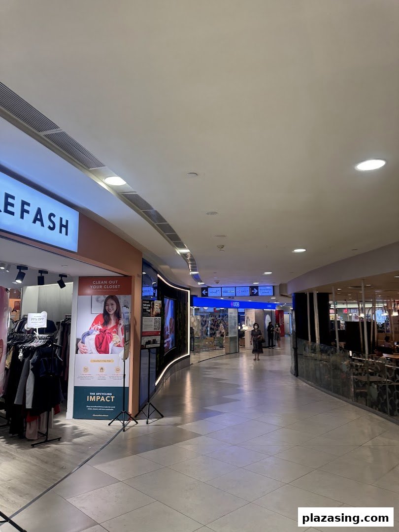 A mall interior showing the UOB branch entrance, other shops, and a wide walkway.