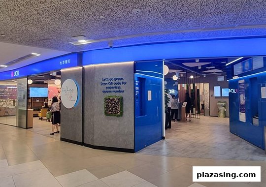 The modern entrance of UOB Bank's Orchard Branch, featuring blue lighting and a digital queue system.