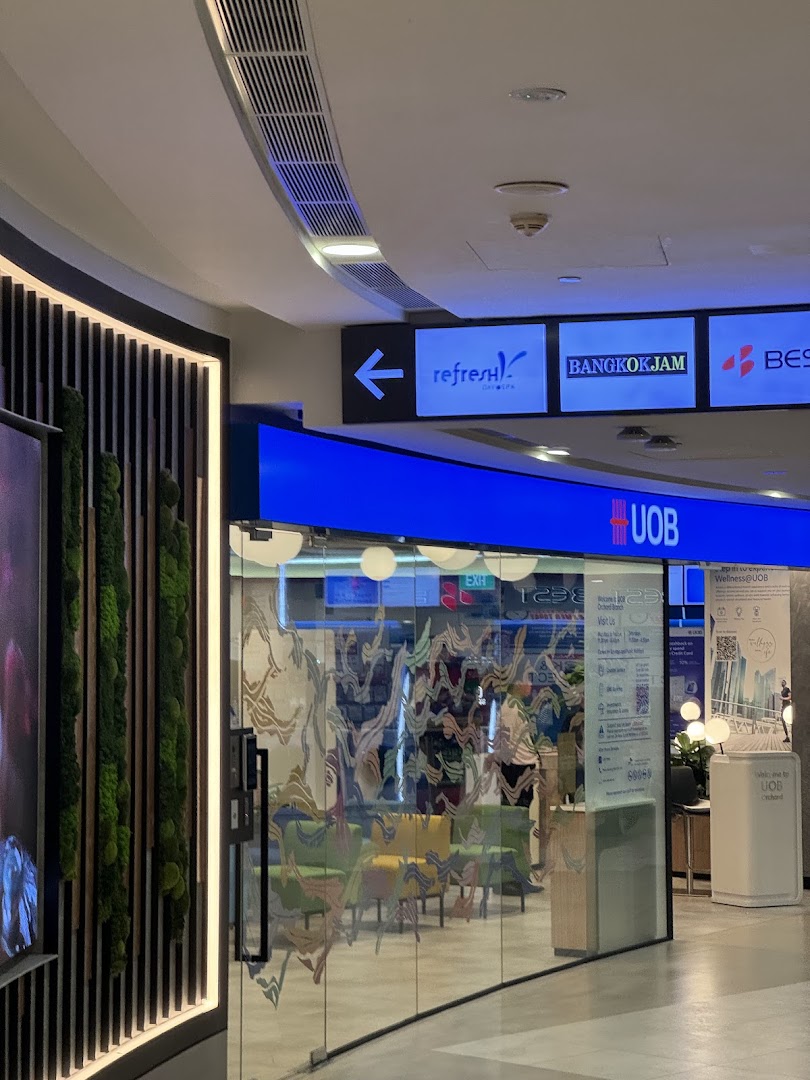 The glass entrance of the UOB Orchard bank branch with interior seating visible.