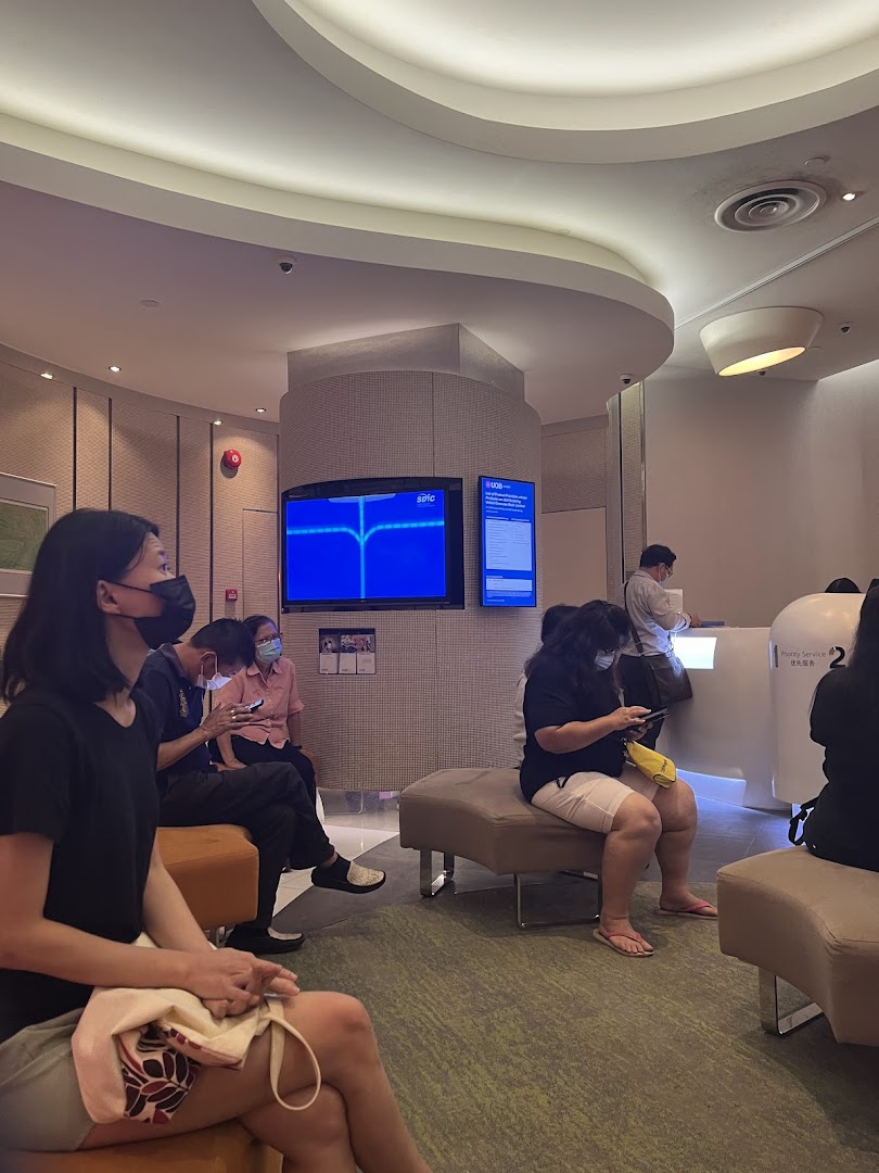 Customers wait in the modern, well-lit interior of a UOB bank branch.