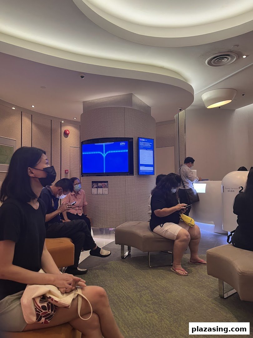 Customers wait in the modern, well-lit interior of a UOB bank branch.