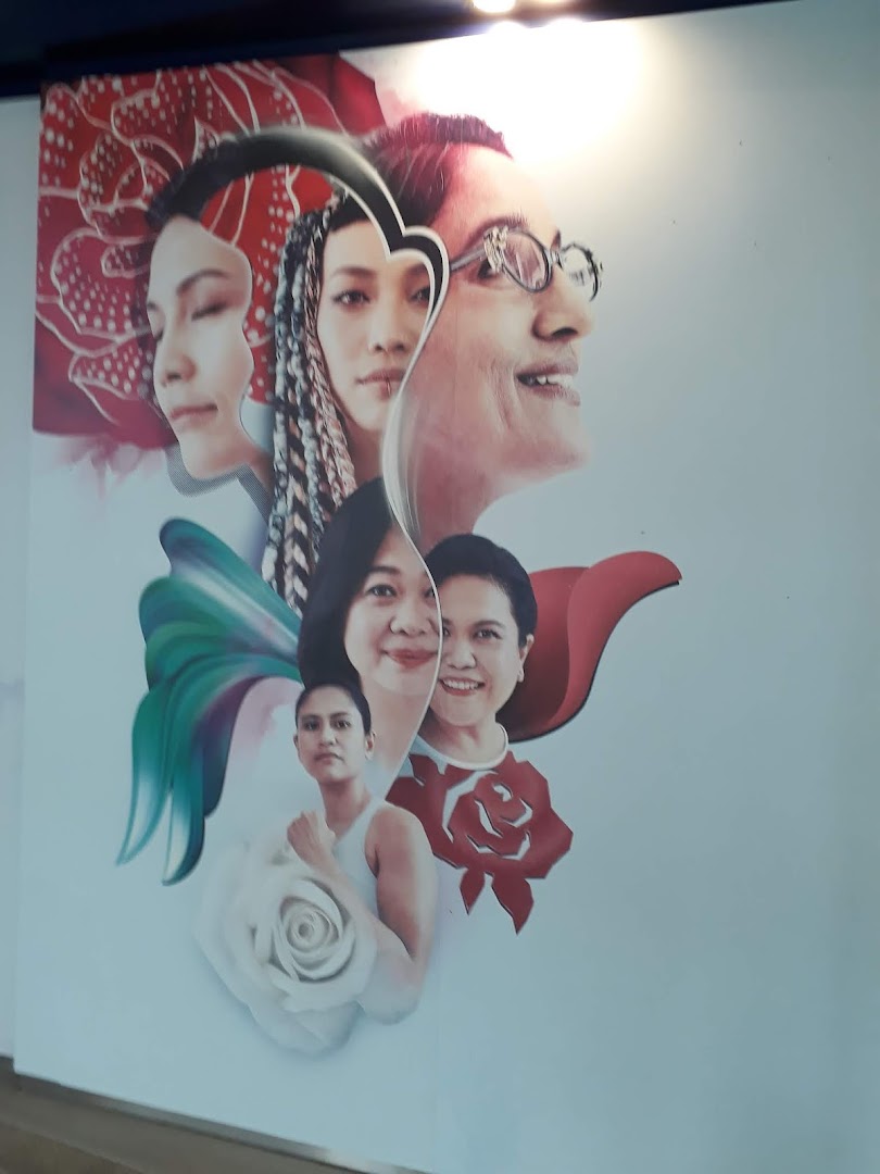 A vibrant mural featuring multiple diverse faces intertwined with floral and abstract elements.