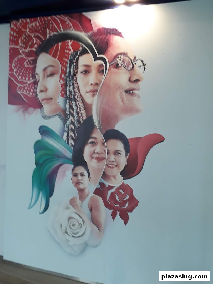 A vibrant mural featuring multiple diverse faces intertwined with floral and abstract elements.