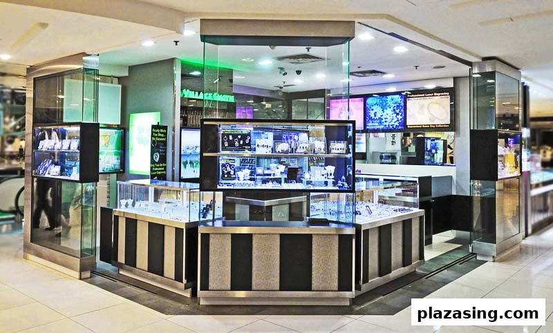 A modern kiosk-style gift and jewelry shop featuring display cases and digital screens in a mall.