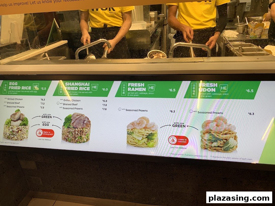 Wok Hey's digital menu board showcasing fried rice, ramen, and udon dishes with prices, and chefs at work.
