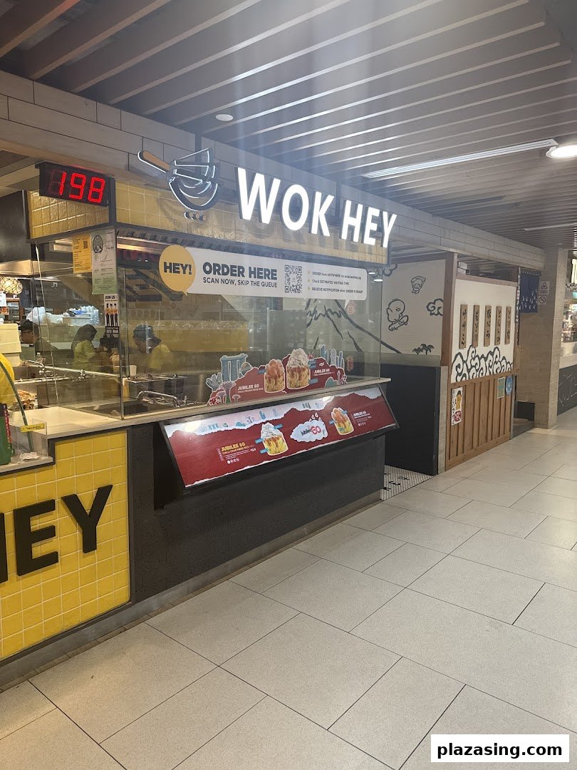 The vibrant WOK HEY shop front with its ordering counter and prominent signage.