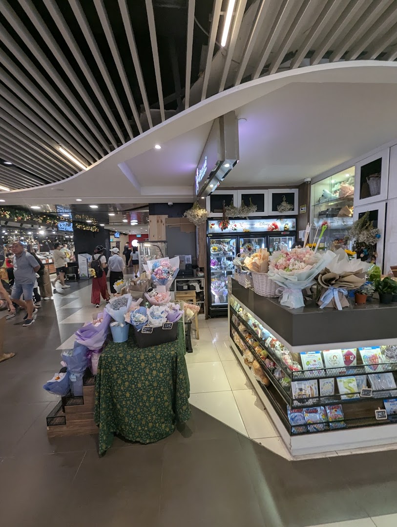 Interior view of Xpressflower, a florist, showcasing colorful bouquets, floral arrangements, and greeting cards.