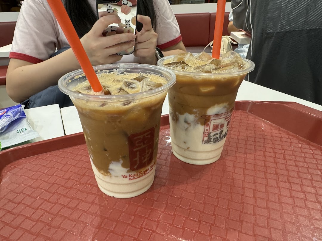 Two refreshing iced coffee drinks from Ya Kun Kaya Toast on a red tray, ready to be enjoyed.