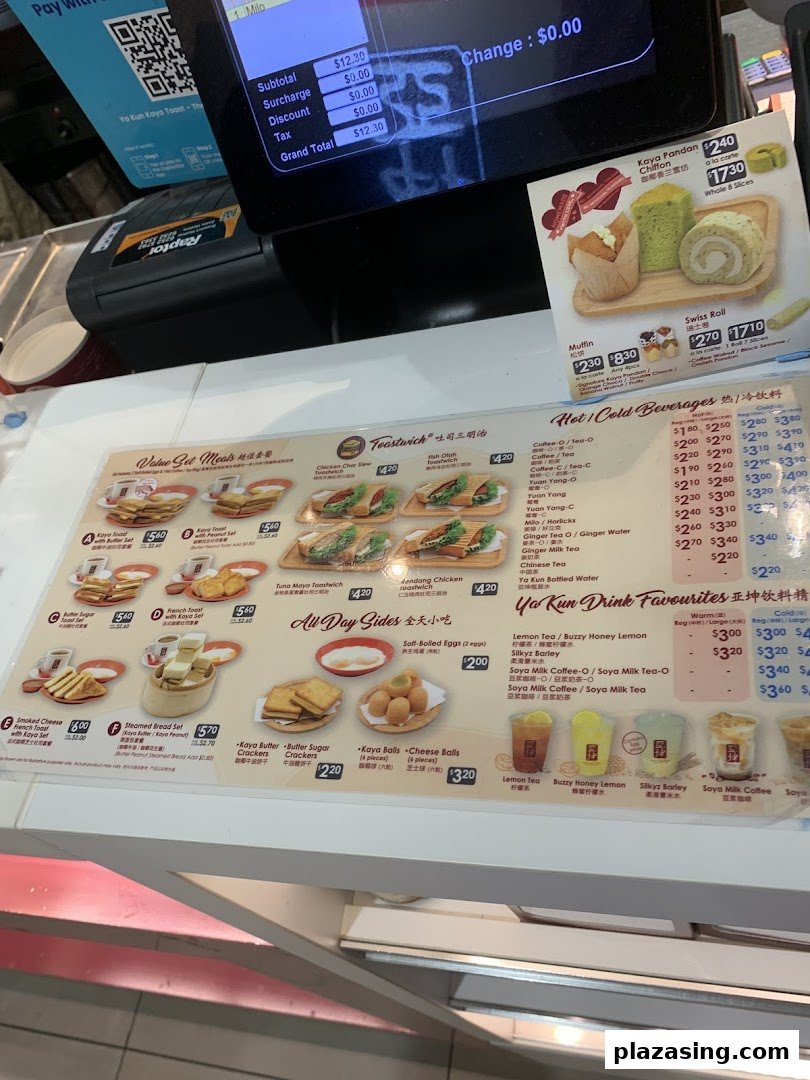 A detailed menu board showcasing various toast sets, sides, and beverages at Ya Kun Kaya Toast.