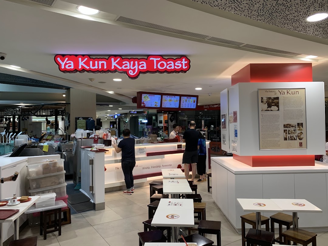An interior view of Ya Kun Kaya Toast, showing the counter, seating area, and customers.