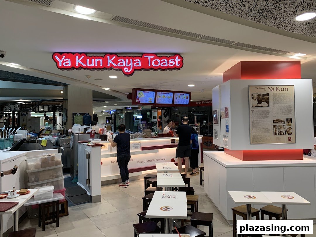An interior view of Ya Kun Kaya Toast, showing the counter, seating area, and customers.