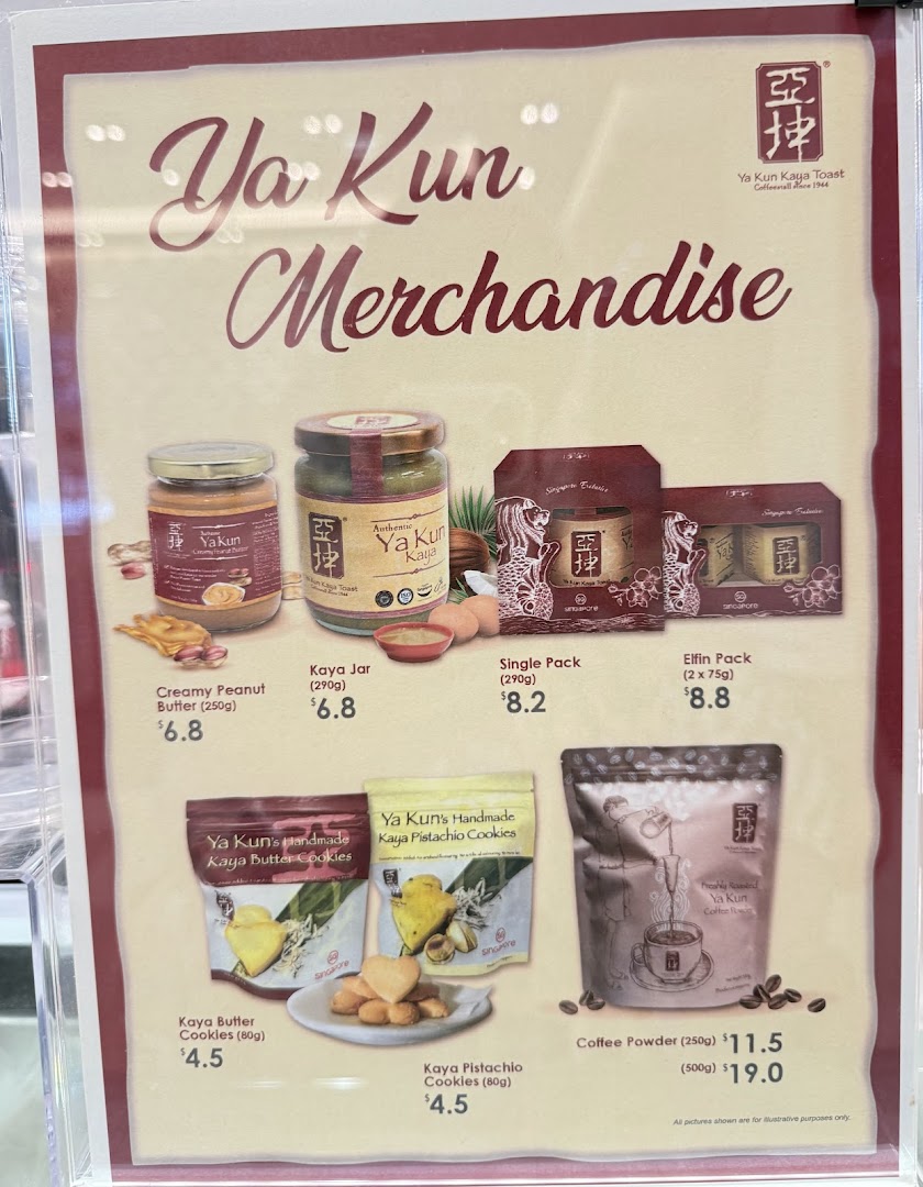A display board showcasing Ya Kun Kaya Toast's merchandise, including spreads, cookies, and coffee powder, with prices.