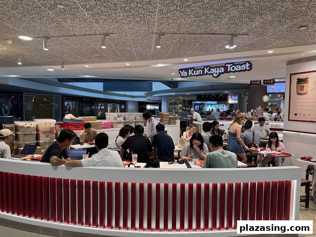 Customers enjoy traditional kaya toast and coffee in the bustling interior of Ya Kun Kaya Toast.